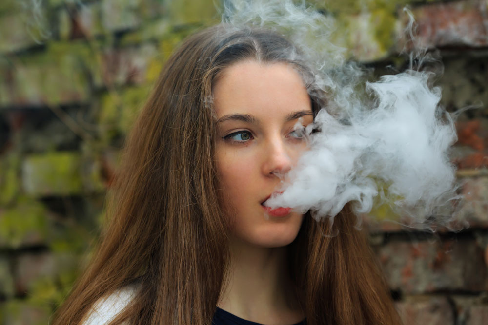 Teenage girl vaping